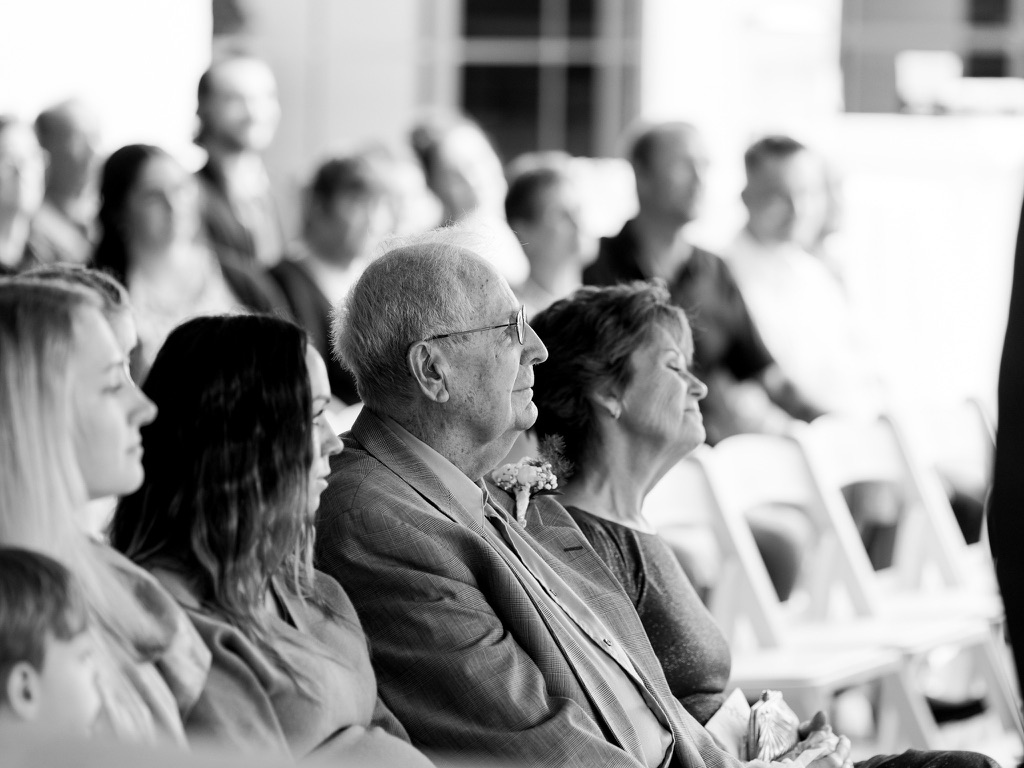 black and white photo of guests at wedding ceremony