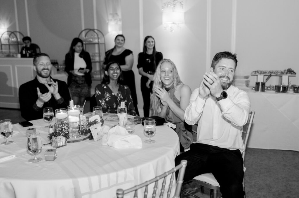 black and white photo of guests at a wedding reception table