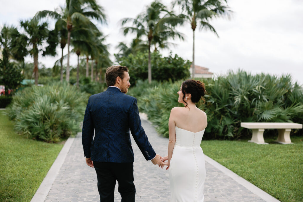 bride and groom holding hands outside