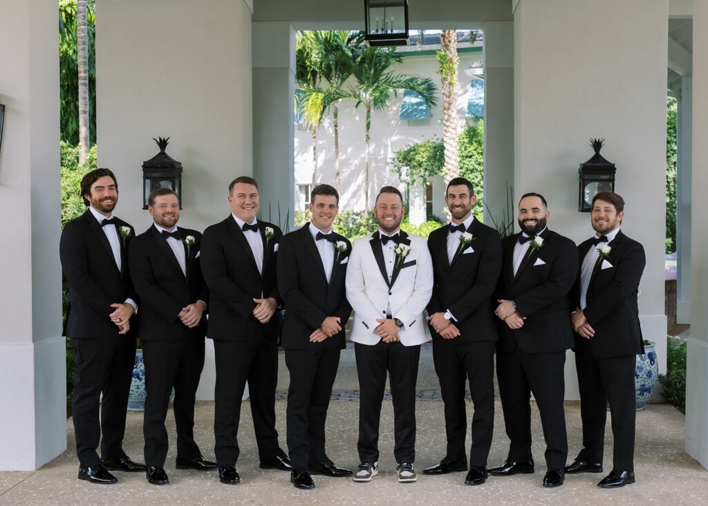 Grooms mean and groom lined up folding their hands in front of them