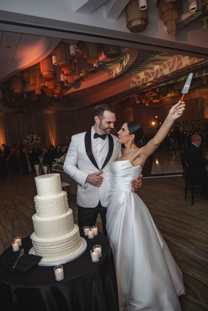 Bride and groom cutting modern white wedding cake at Marriott Harbor Beach reception