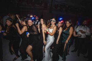Bride dancing with guests on packed reception dance floor at Fort Lauderdale wedding reception