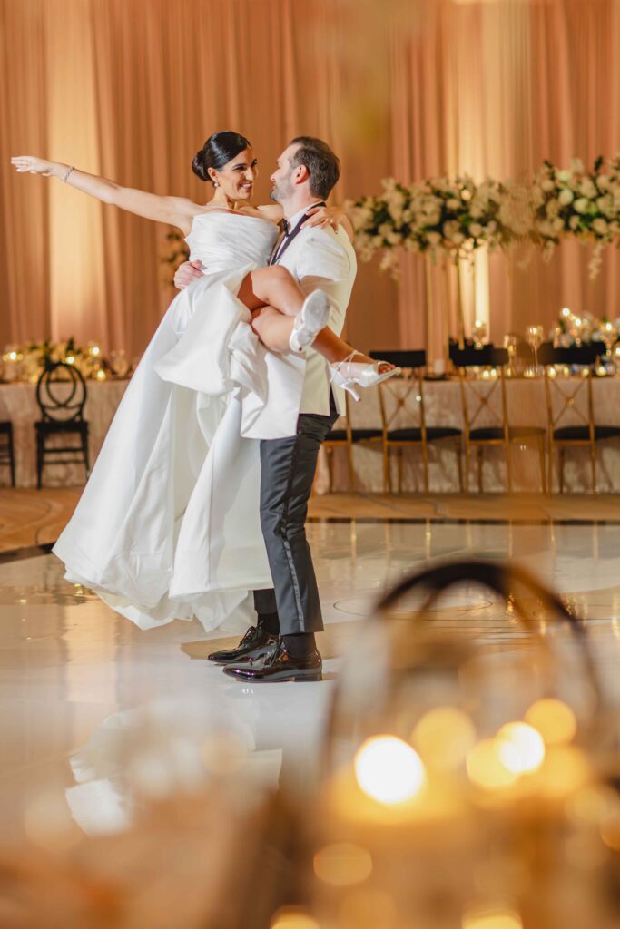 Romantic first dance with candlelight and floral backdrop at Marriott Harbor Beach wedding