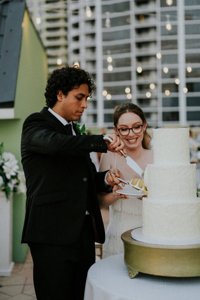 bride and groom cutting a 3 tier cake